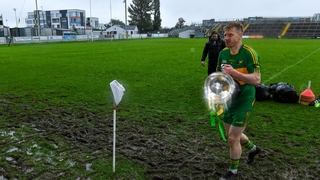 Rhode captain Niall Darby carries the Dowling Cup off the field