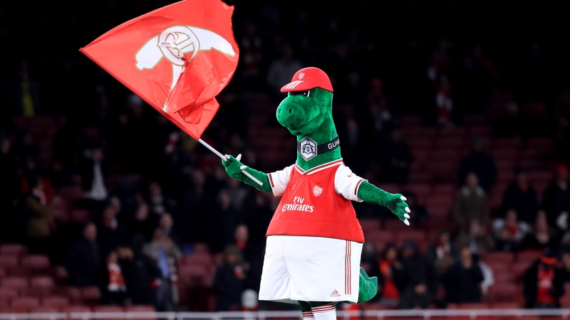 Gunnersaurus, the Arsenal mascot, on the pitch at the Emirates Stadium in London