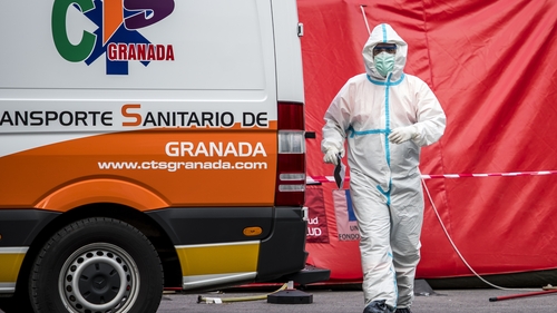 A paramedic is seen near his vehicle at the Virgen de las Nieves hospital in Granada, Spain