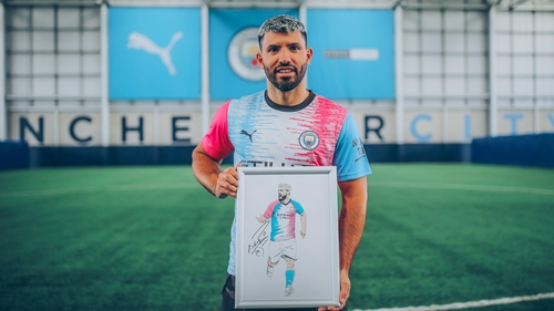 Sergio Aguero tries on the winning kit
