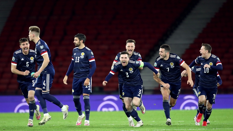 The Scottish players show their delight at advancing