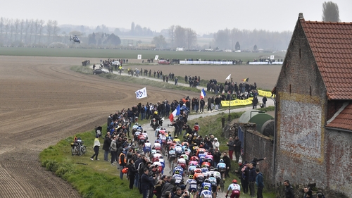 Riders race over the famed cobblestones during the 117th edition of the Paris-Roubaix in 2019