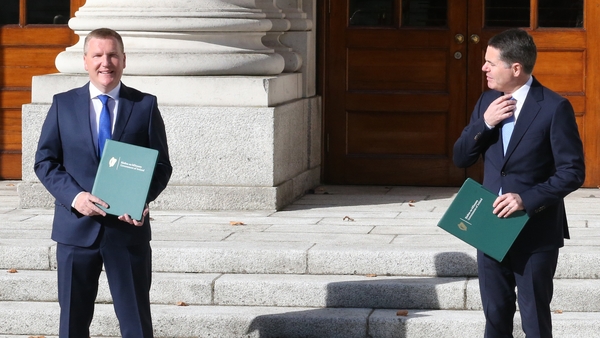 Ministers Michael McGrath and Paschal Donohoe pose for photographers at Government Buildings this afternoon