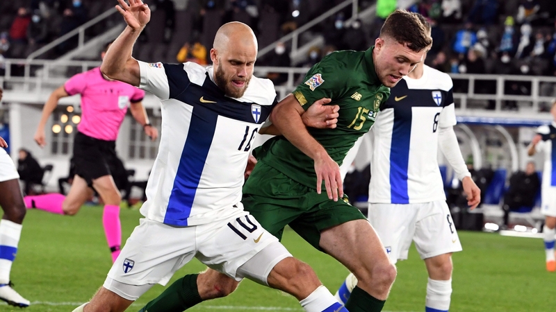 Dara O'Shea battles with Finland striker Teemu Pukki during the game in Helsinki