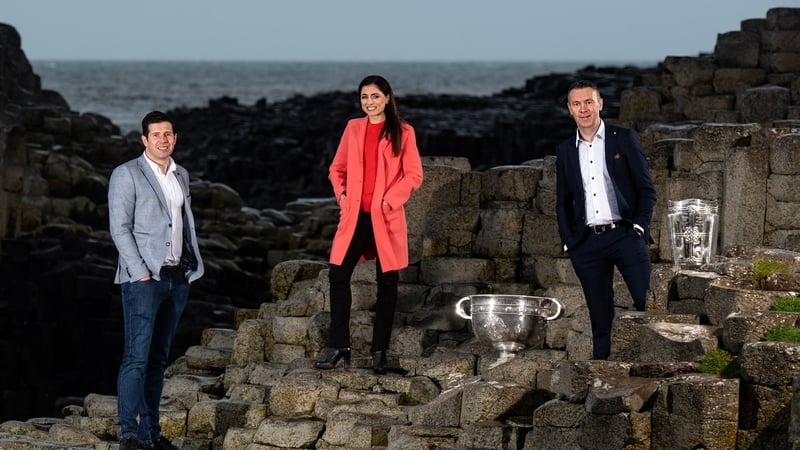 Seán Cavanagh, Joanne Cantwell and Oisín McConville with the Sam Maguire and Liam MacCarthy