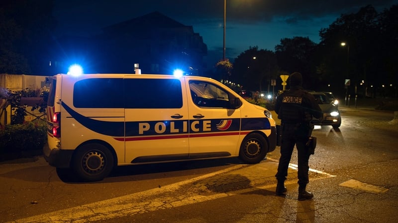 French police officers stand guard near the scene of the stabbing in Paris