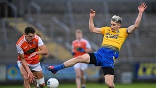 Cathal Compton of Roscommon gets to the ball ahead of Niall Grimley of Armagh