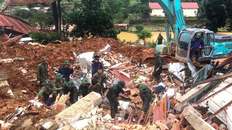 Military personnel search for missing soldiers at the site of a landslide in central Vietnam's Quang Tri province