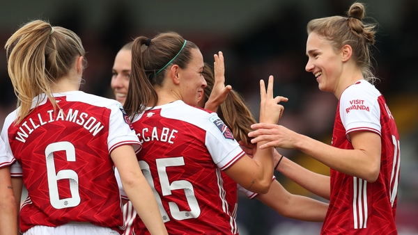 Katie McCabe and Vivianne Miedema (r) celebrate a commanding derby win