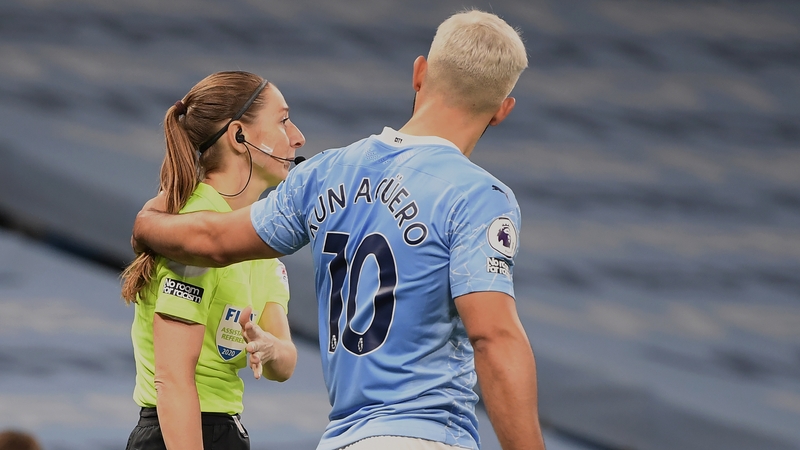 Assistant referee Sian Massey-Ellis and Sergio Aguero