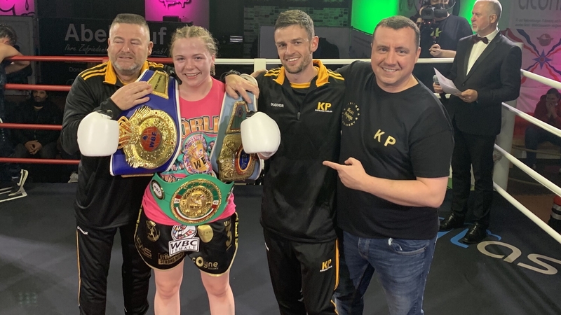 Katelynn Phelan poses with the belts following the win in Germany