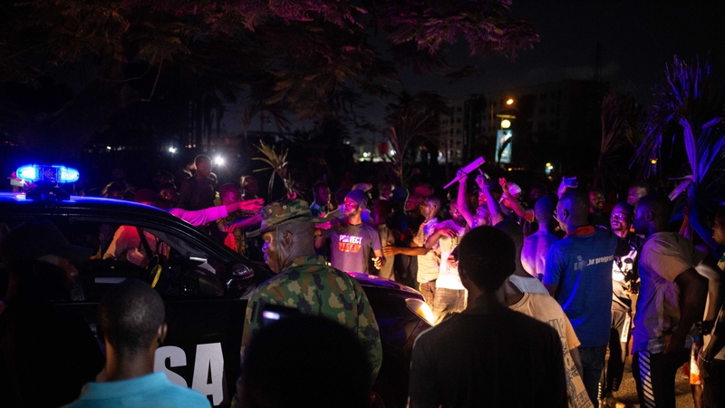 Witnesses said armed gunmen opened fire on a crowd of over 1,000 people to disperse them after a curfew was imposed