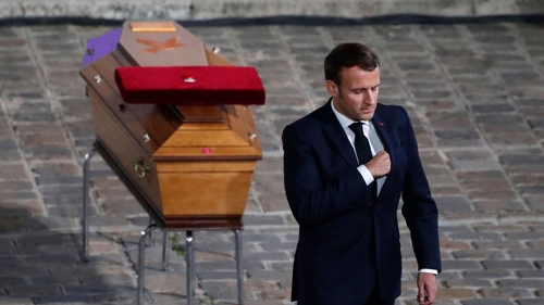 French President Emmanuel Macron pays his respects by the coffin of Samuel Paty