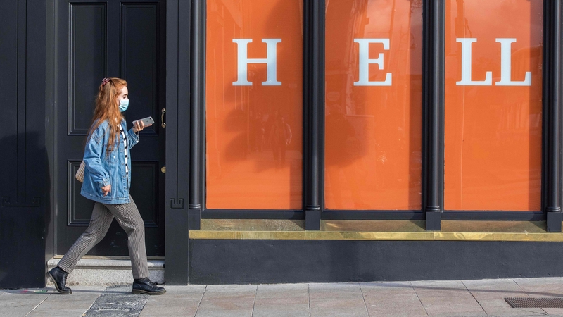 A woman walks past a store in Dublin the day before Ireland begins a second national lockdown. Photo: Paul Faith/AFP via Getty Images