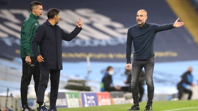 Manchester City manager Pep Guardiola (right) gestures towards FC Porto manager Sergio Conceicao on the touchline