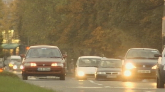 Cars driving with headlights on during the day (2000)