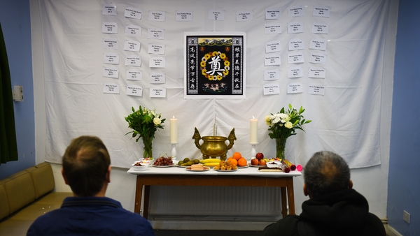 Those paying their respects throughout the morning lit incense, wrote tributes in a book and sat in silence before a wall displaying the names of those who died