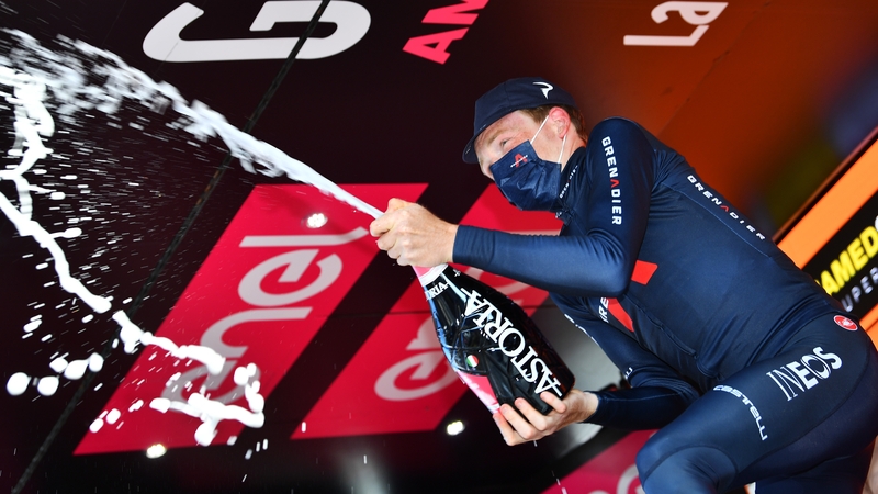 Tao Geoghegan Hart celebrates on the podium