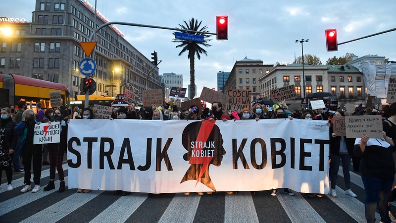Protesters with a banner 'Women's Strike' block a street in the city center during a protest against the tightening of the abortion law in Warsaw