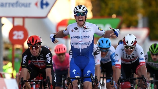 Sam Bennett celebrates crossing the line