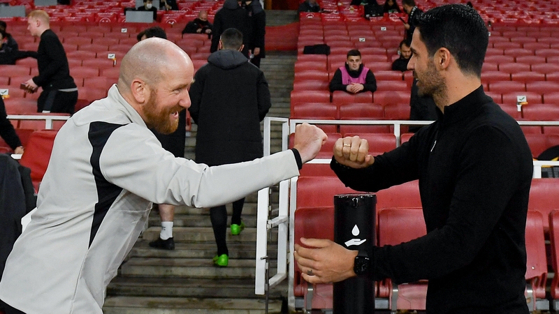 Dundalk opposition analyst Shane Keegan (L) bumps fists with Mikel Arteta