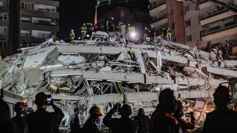 Rescuers search for survivors at a collapsed building in Izmir
