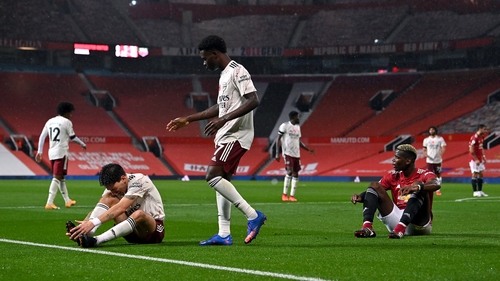 Manchester United's Paul Pogba (R) reacts after conceding a penalty for a foul on Hector Bellerin (L)