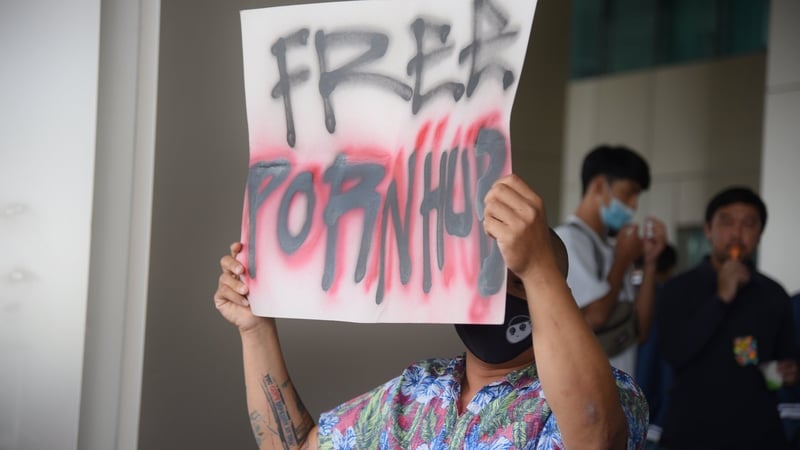 A protester holds a placard during a demonstration at the Ministry of Digital Economy in Bangkok, Thailand following porn ban