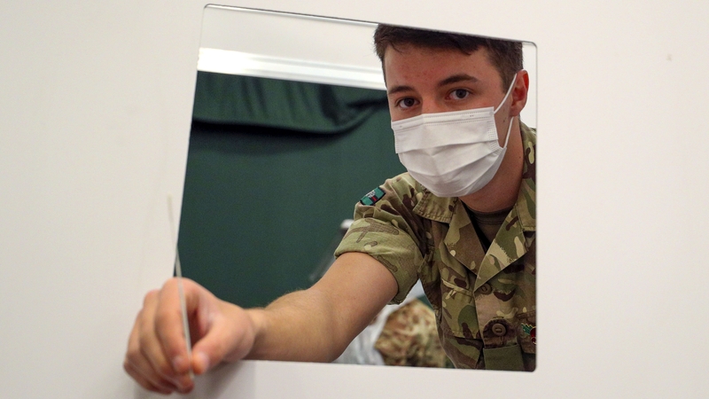 A British soldier prepares to swab people at Liverpool Tennis Centre