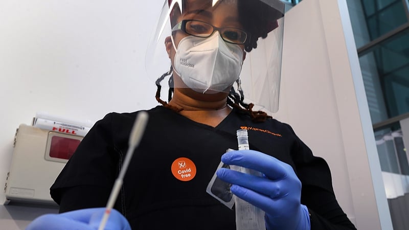 A health worker in Boston prepares to administer a Covid-19 test