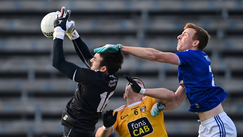 Oisin Kerr, left, and James McAuley of Antrim in action against Jason McLoughlin of Cavan