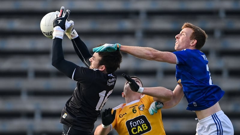 Oisin Kerr, left, and James McAuley of Antrim in action against Jason McLoughlin of Cavan