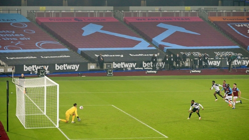 Lukasz Fabianski (L) saves the penalty