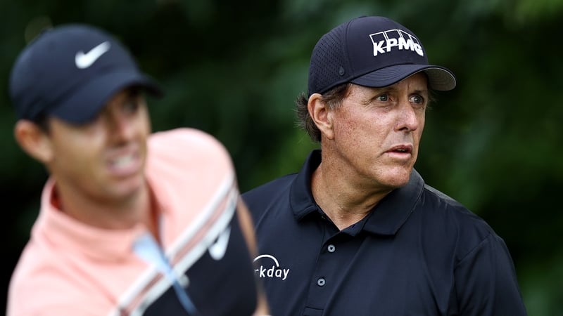 Rory McIlroy (L) with Phil Mickelson