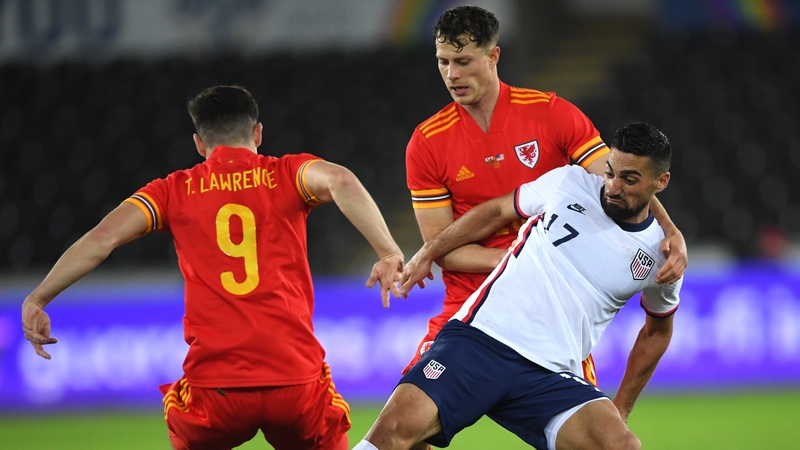 Sebastian Lletget of USA is tackled by Wales' Tom Lawrence