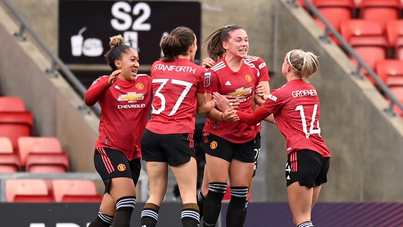 Kirsty Hanson celebrates with teammates after her equaliser for United