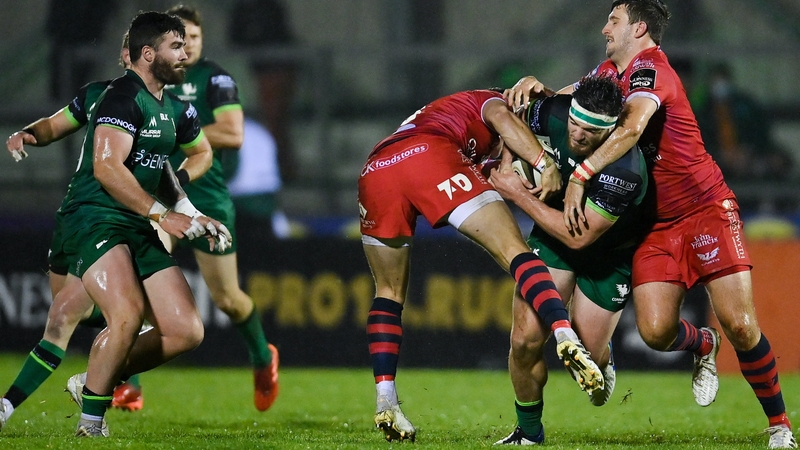 Tom Daly of Connacht is tackled by Scarlets' Steff Hughes, left, and Dan Jones at the Sportsground.