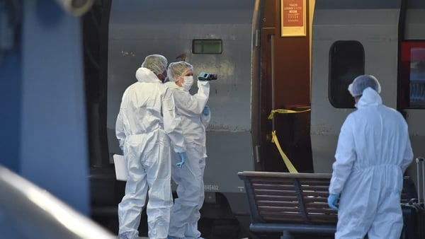 Police officers inspect the train following the attack