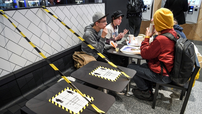 Tables at a fast food restaurant in Stockholm are taped off to allow for social distancing (file image)