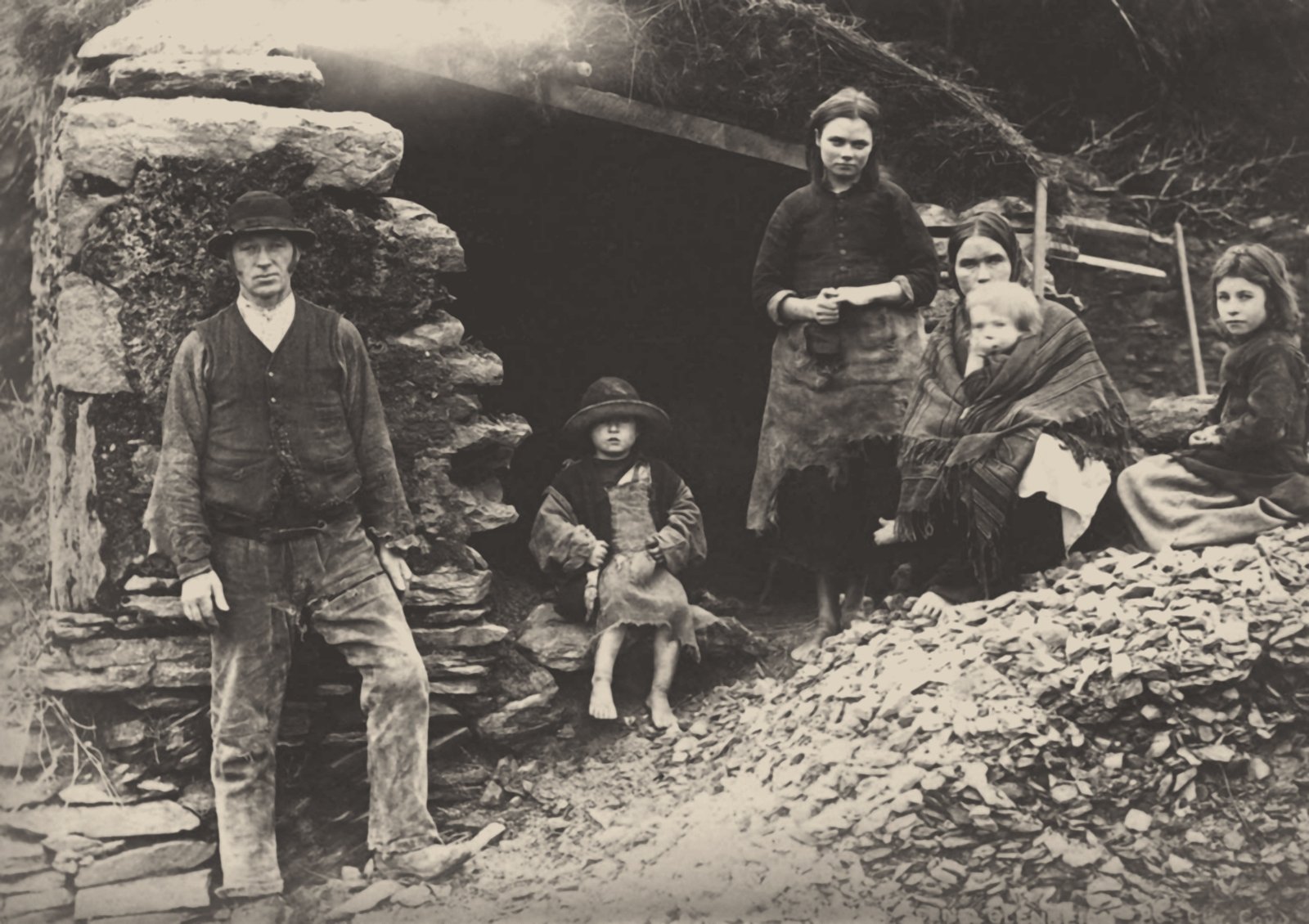 A family at the ruins of their house in Killarney, 1888 in a private collection. (Photo: Fine Art Images/Heritage Images/Getty Images)