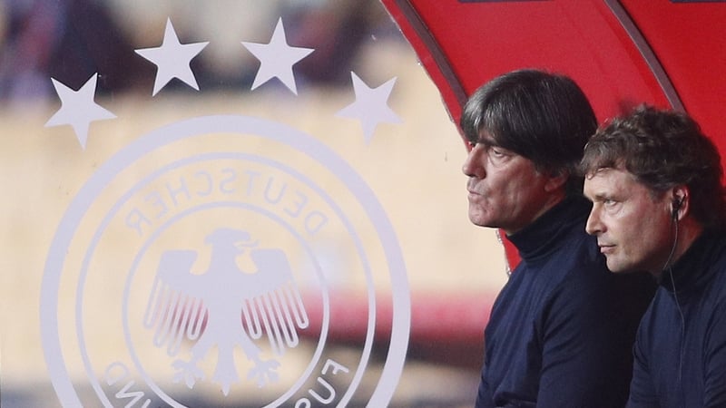German head coach Joachim Loew (L) and assistant coach Marcus Sorg watch their team slump to a 6-0 loss