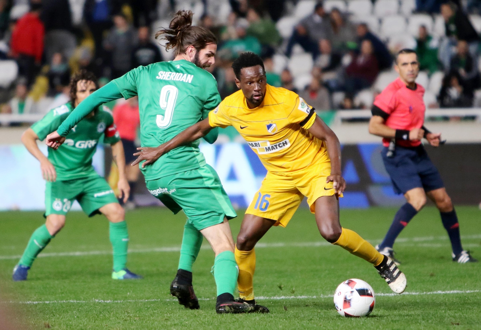 APOEL FC's Vinicius Oliveira Franco (R) fights for the ball against Sheridan's Omonia in the derby