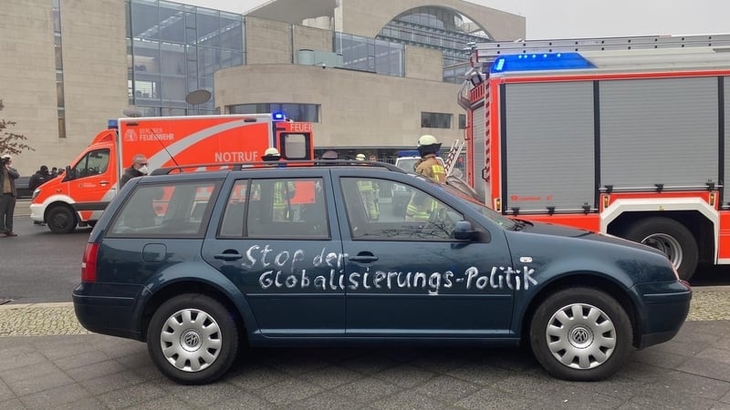 'Stop Globalisation Politics' is seen written on the side of the car
