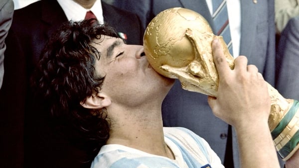 Maradona, pictured with the 1986 World Cup trophy, died of a heart attack last month at the age of 60