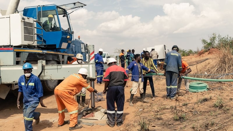 Rescue workers installing a water pump to drain water from the mine shaft