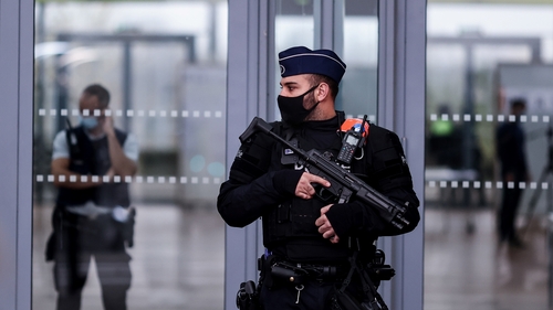 Belgian police officers stand guard at the entrance to Antwerp courthouse