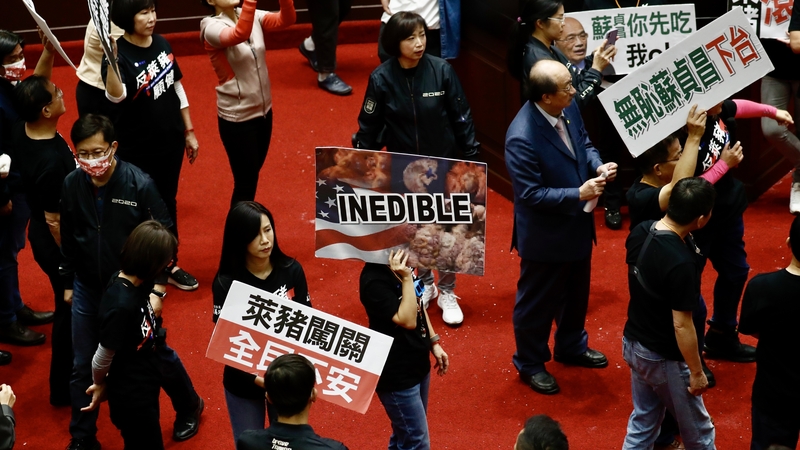 Politicians from the opposition Kuomintang (KMT) party dumped buckets of pork offal on the debating chamber floor during a protest
