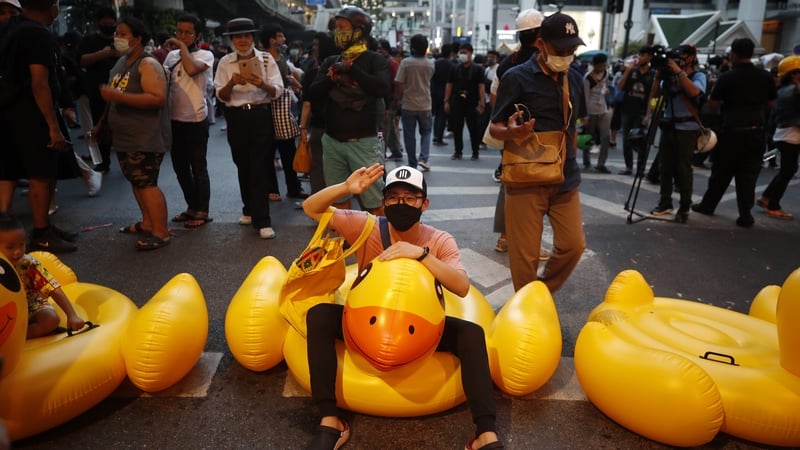 Pro-democracy protesters on inflatable rubber ducks during a protest in Bangkok, Thailand