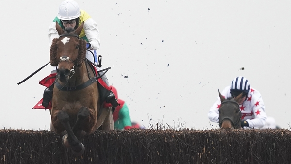 Tom Scudamore and Cloth Cap clear the last to win The Ladbrokes Trophy Chase at Newbury.