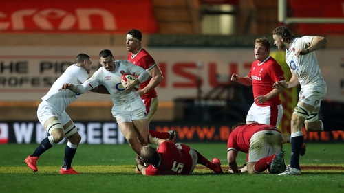 England's winger Jonny May is tackled by Welsh lock Alun Wyn Jones